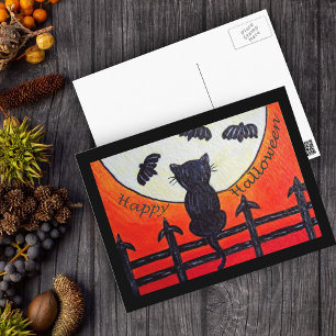 Gato de Halloween en una cerca en la postal de la
