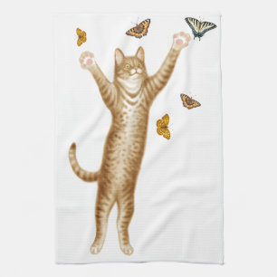 Gato del gatito con la toalla de cocina de las