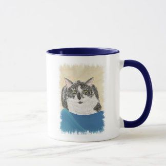 Gato esmoquin sobre pintura de manta azul, tazas