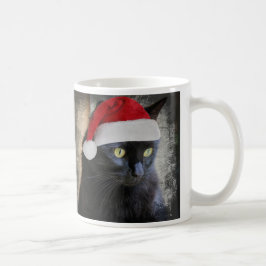 Gato lindo del navidad en el gorra de Santa, taza