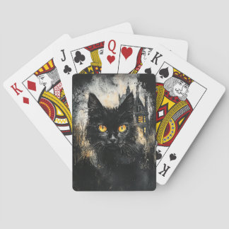 Gato negro y una cubierta de cartas de juego en ca