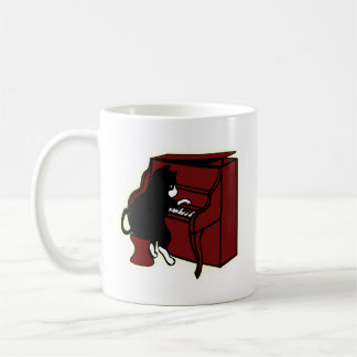 Gato que juega la taza del piano