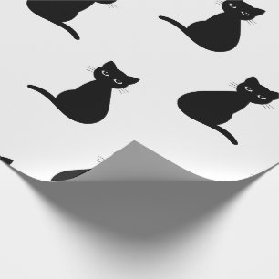 Gatos negros envolviendo papel
