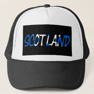 Gorra De Camionero Escocia colocada sobre la bandera escocesa