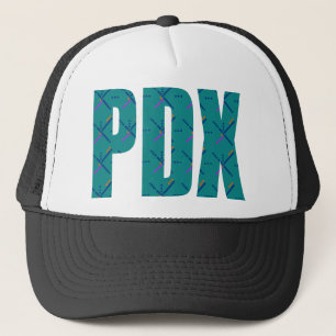 Gorra De Camionero PDX pone letras a la alfombra del aeropuerto de