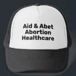 Gorra De Camionero Tipografía negra de la asistencia y el aborto<br><div class="desc">Ayuda y Abet Abortion Healthcare negro negrita tipografía Trucker Hat. Texto completamente personalizable de diseño moderno minimalista. El movimiento a favor del derecho al aborto es un movimiento sociopolítico en Estados Unidos que apoya la opinión de que una mujer debe tener el derecho legal a un aborto electivo, lo que...</div>
