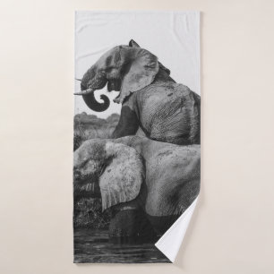 GRAYSCALE PHOTO OF TWO ELEPHANTS ON BODY OF WATER
