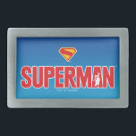 Hebilla De Cinturón Rectangular Logo en negrita de Superman clásico<br><div class="desc">¡Traiga energía atemporal de superhéroes a su estilo con este impresionante diseño de Superman! Con el atrevido texto rojo "SUPERMAN" con una silueta del Hombre del Acero heroicamente posada dentro de la letra, esta obra de arte aparece con un elegante fondo azul gradiente. Con el icónico escudo "S" rojo y...</div>