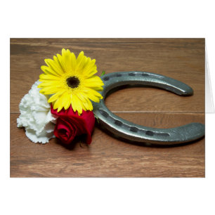 Herradura en la madera con tres flores de la tripl