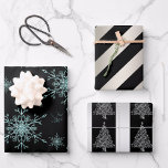 Hoja De Papel De Regalo Black and Silver Christmas<br><div class="desc">A black and silver-themed Christmas wrapping paper set of three different designs. The first sheet features a pattern of crystal blue/silver glitter snowflakes on a black background, the second sheet has a pattern of black and silver diagonal stripes, and the third sheet features another silver striped pattern with little silver...</div>