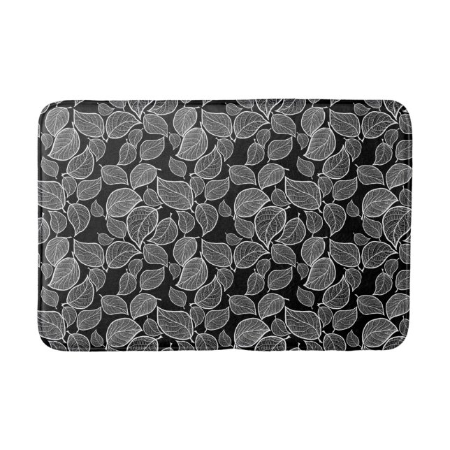 Hojas blancas sobre alfombrilla negra de baño (Anverso)
