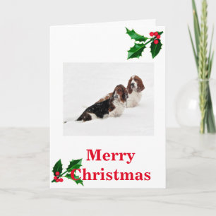 Hounds de Basset en la nieve en tarjeta de Navidad