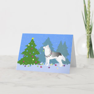 Husky siberiano decorando árbol de Navidad - Bosqu