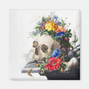 Imán con calavera y escena de flores.