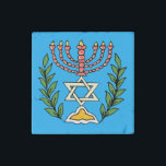 Imán De Piedra Magen persa David Menorah<br><div class="desc">Esta imagen fue adaptada de una antigua teja judía persa y cuenta con una menorah con un Magen David (Estrella de David) enmarcado por ramas de olivo. Se han conservado las imperfecciones de la imagen original pintada a mano.</div>