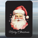 Imán El retro vintage Santa Claus Black Merry Christmas<br><div class="desc">Con este imán retro de Navidades de Santa Claus, podrá darle un toque nostálgico a su casa. Con un delicioso ilustracion de Santa sobre un fondo negro con las palabras "Feliz Navidad", este imán es perfecto para decorar tu frigorífico o cualquier superficie magnética durante la temporada festiva. Ideal para disfrutar...</div>