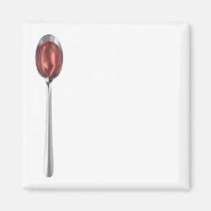 Imán Jarabe rojo en cuchara de plata