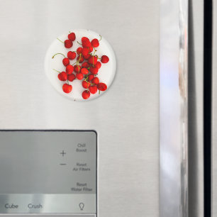 Imán Las cerezas rojas con luz natural yacen en blanco