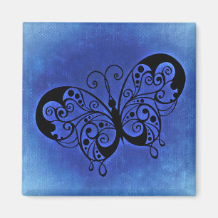 Imán Mariposa brillante en fondo de denim azul