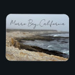 Imán Morro Bay California Ocean Cliffs Photography<br><div class="desc">A foggy overcast day in Morro Bay California with the ocean waves hitting the rocks on the shore in this beach photograph souvenir. This seaside travel photo keepsake magnet gift features black cursive script above the beach rocks and grey sky.</div>