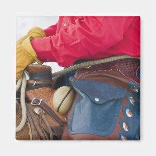 Imán Vaquero a caballo que lleva polainas de cuero