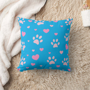 Impresión de pata rosa y blanca y almohada azul ca