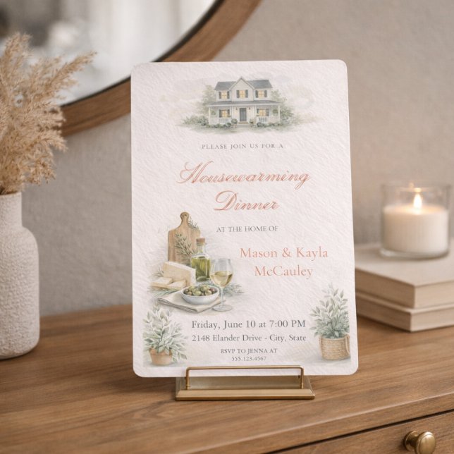Invitación a Cena de Calentamiento de Hogar (Warm housewarming dinner invite with blush tones, wine and cheese details, and soft greenery)