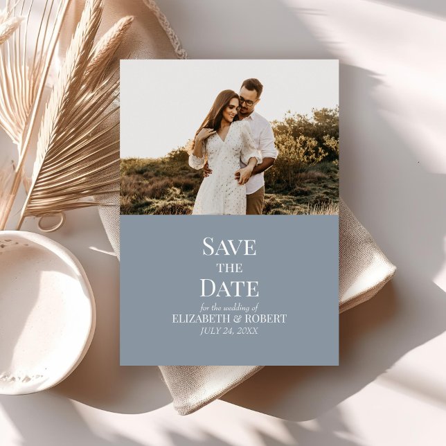 Invitación Moderna foto de Personalizado azul turbio salva la (Modern Dusty Blue Custom Photo Save the Date Card on a neutral boho table with dry palm leaf.)
