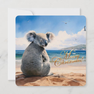 Koala en una playa de arena Feliz Navidad