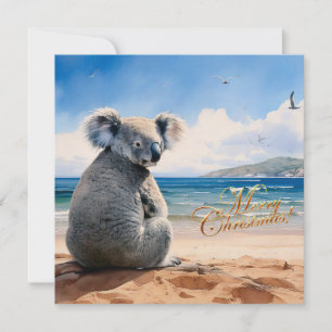 Koala en una playa de arena Feliz Navidad