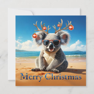 Koala en una playa de arena Feliz Navidad