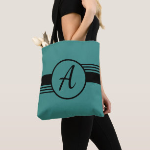 La bolsa de asas azul y negra del monograma de