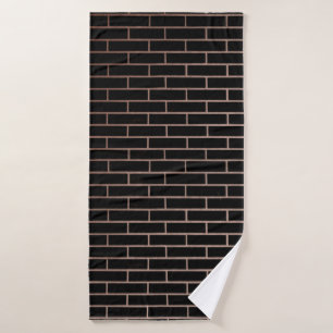 La pared de ladrillo negro oscuro tiene una superf