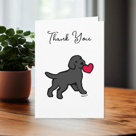 Labrador negro con tarjeta de agradecimiento