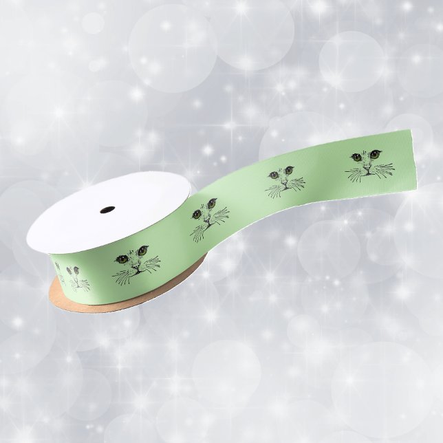 Lazo De Raso Gato Face Green Eyes Whiskers (black illustration of the face of a cat long whiskers green eyes on roll of green gift wrap ribbon.)