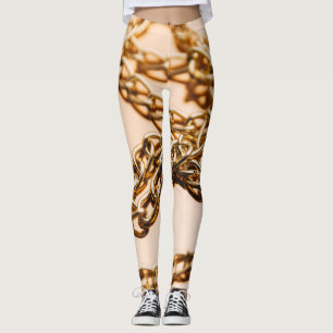 Leggings Cañones doradas, lujo reflexante en la superficie.