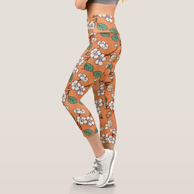 Leggings Capri Naranja de diseño floral blanca (Izquierda)
