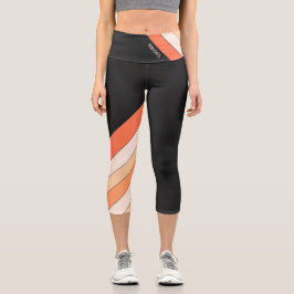 Leggings Capri Rayas negras y naranjas en una pierna