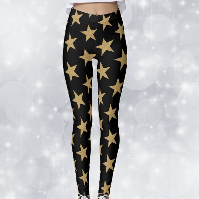 Leggings Grandes estrellas de Navidades de oro en negro (Big festive gold holiday stars on black woman's leggings.)
