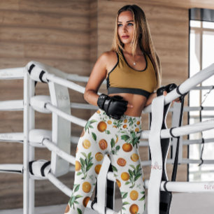 Leggings Naranjas con patrones de fruta blanca Piernas