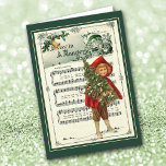 Lejos de la tarjeta de Navidades de arte musical<br><div class="desc">Aquí hay una hermosa tarjeta de Navidades hecha con una vintage carta de arte de un niño de la época victoriana vestido con una capa roja y patatas de punto marrón que llevan un árbol de Navidad. La imagen se coloca delante de las palabras y la música para "Away in...</div>