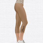 Leopard Pattern Om Symbol Capri Leggings<br><div class="desc">El símbolo Om de patrón leopardo está enlosado en la cintura, las leggings capri son marrón claro. Nombre en negro en el exterior de ternera derecha. Cambiar o quitar fácilmente el nombre mediante la plantilla proporcionada. Hay amplio espacio para un nombre completo u otro texto. Tamaños de XS (0-2) a...</div>