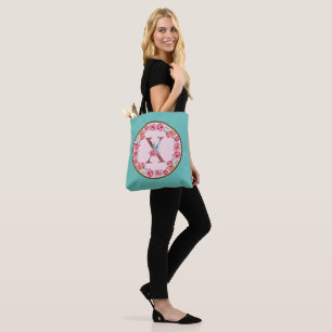 Letra monograma X con bolsa de té con imagen de la