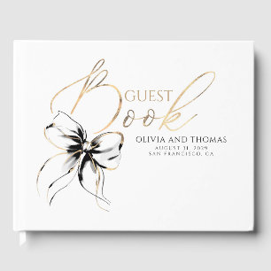 Libro de invitados con guión dorado y lazo negro