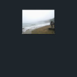 Lienzo Foggy Scarborough Beach<br><div class="desc">Immerse yourself in the serene, misty beauty of Scarborough's coastline on a foggy day. This atmospheric image captures the calm waves of the North Sea gently rolling onto the unique brick-patterned beach, with the iconic Scarborough hills fading into the distance. Perfect for those who appreciate the moody charm of coastal...</div>