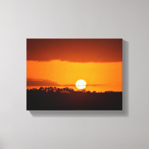 Lienzo Majestuosa puesta de sol sobre el río