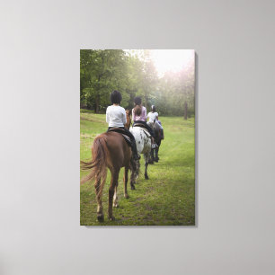 Lienzo Niñas pequeñas montando caballos