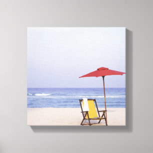 Lienzo Silla y paraguas de playa por el océano