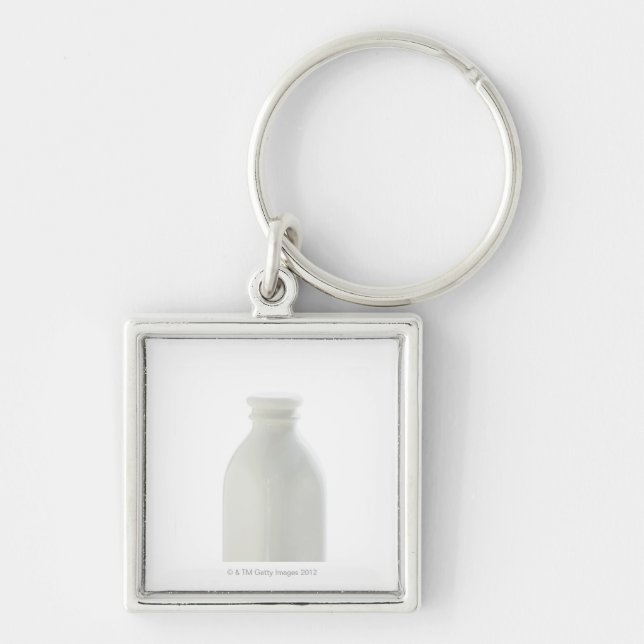 Llavero Botella de leche en el fondo blanco (Frente)