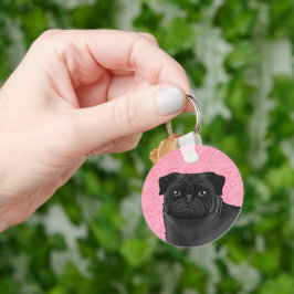 Llavero Cabeza de perro Pug negro en primer plano sobre co